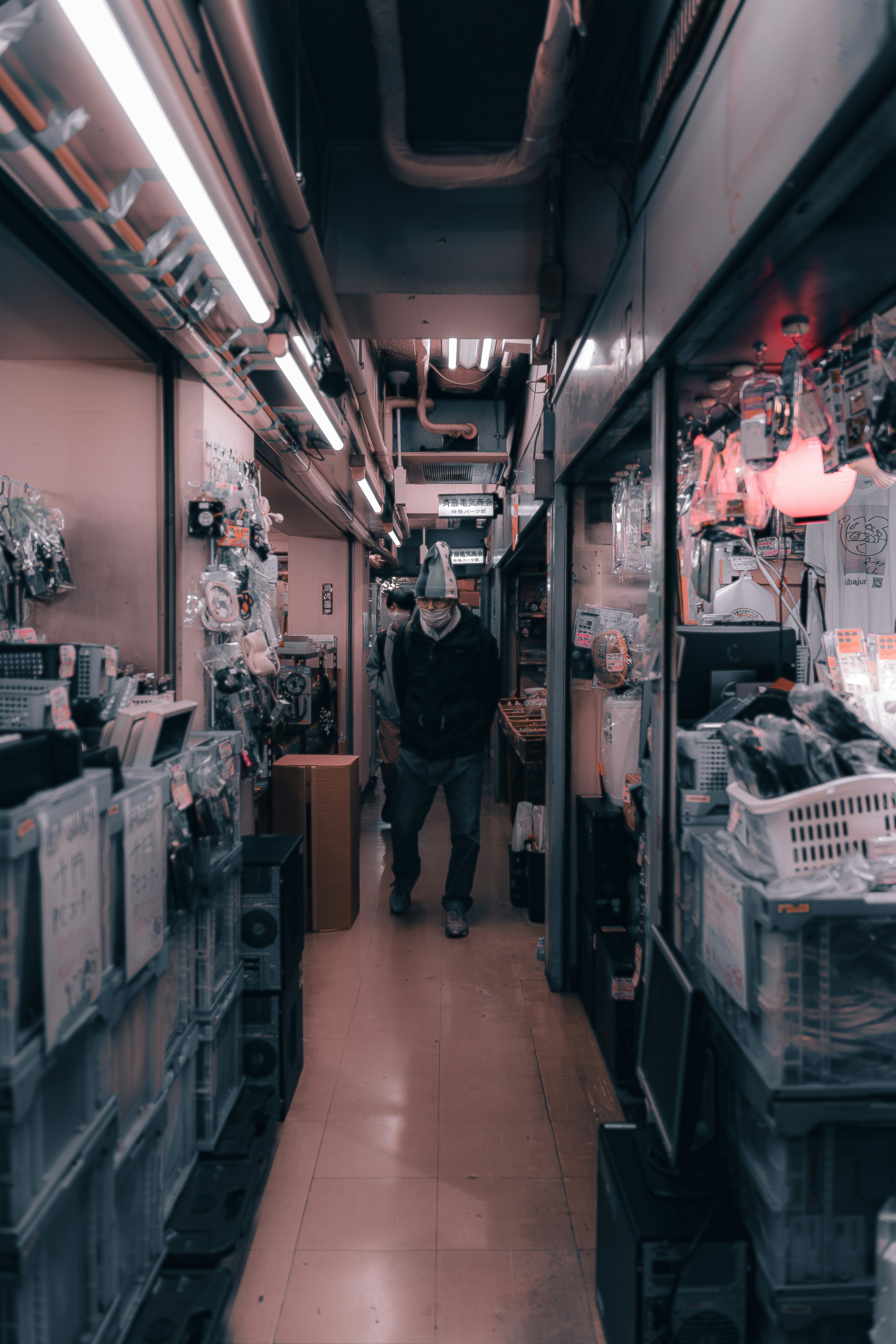 a man walking down a long narrow hallway