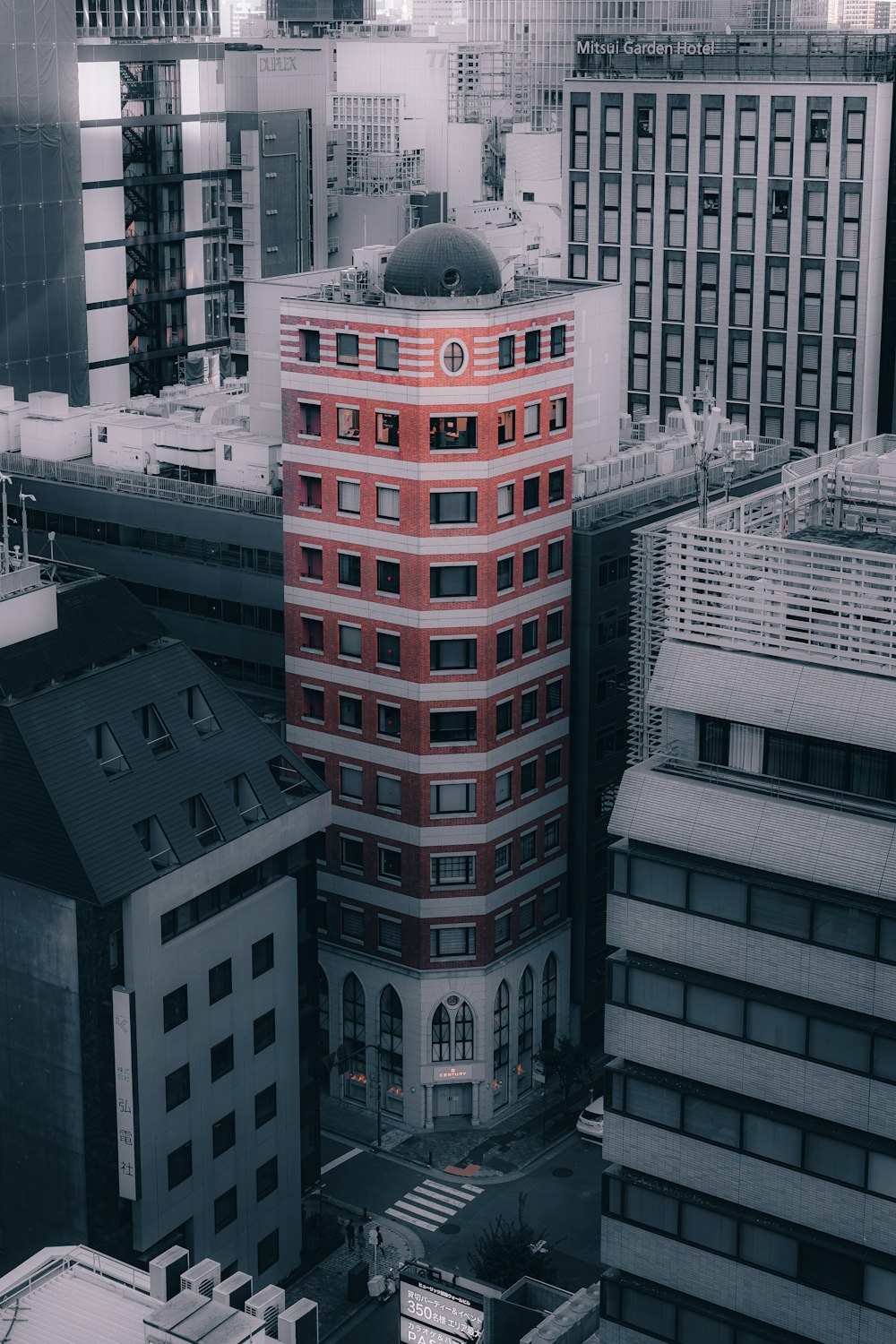 a red and white building in the middle of a city