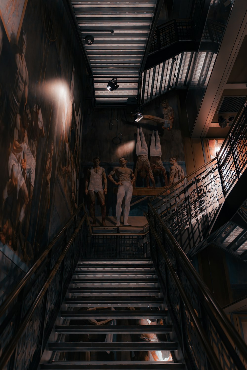 a staircase leading up to a painting of baseball players