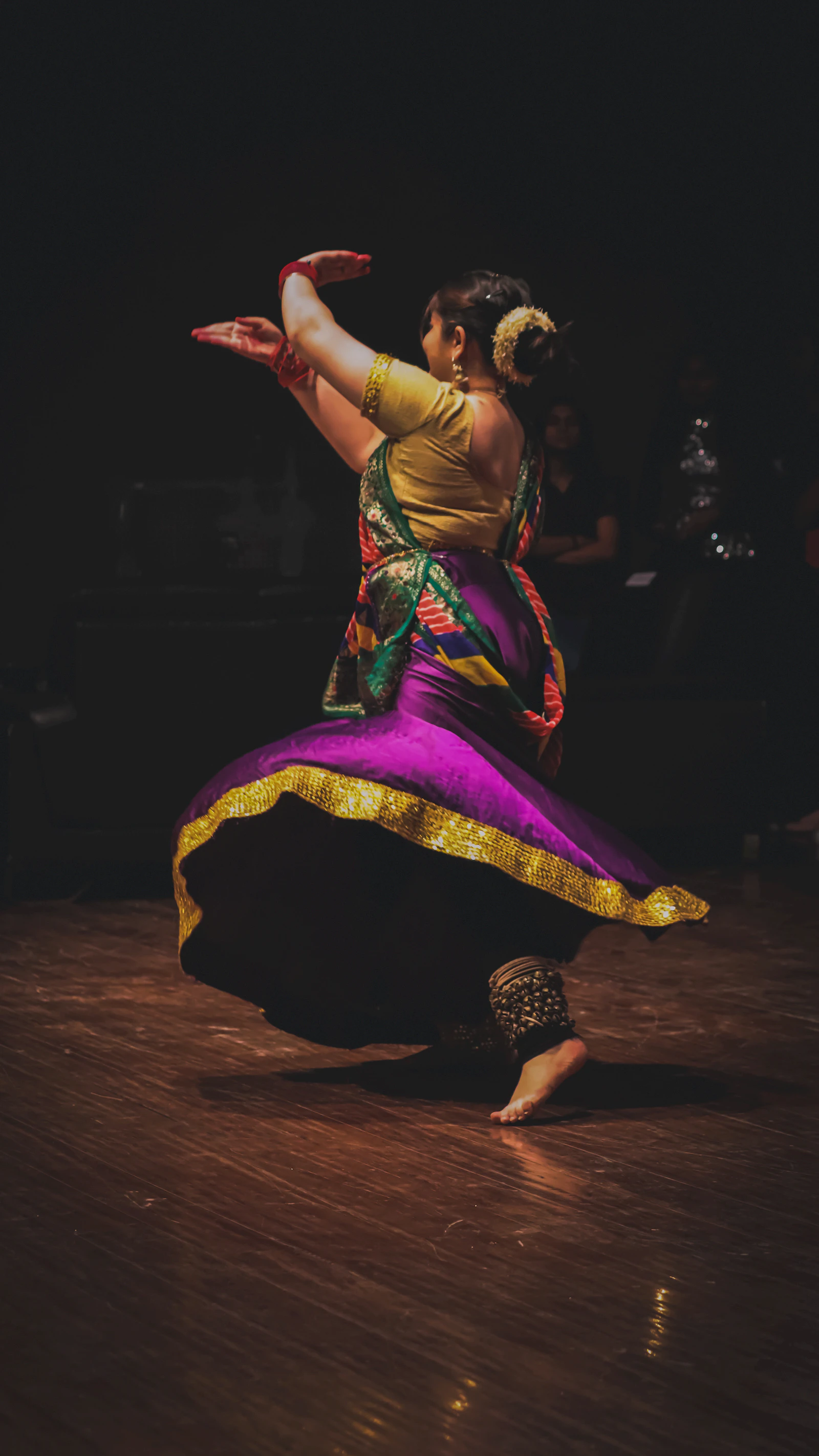 Dancer in colourful dress mid-spin
