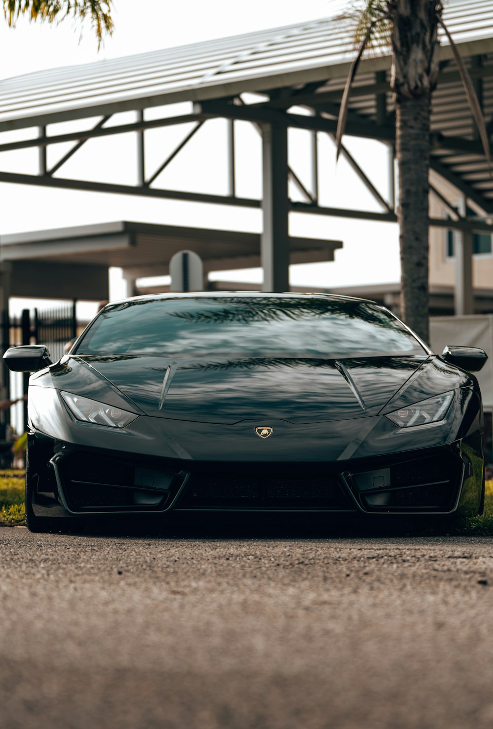 a black sports car parked in front of a building