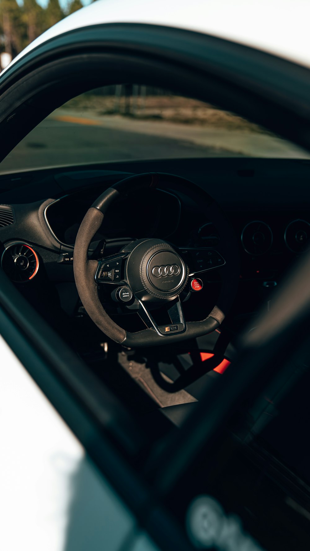 a white car with a steering wheel and dashboard