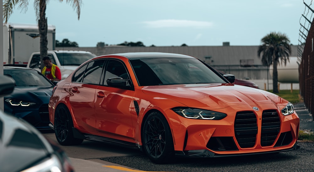 an orange sports car parked in a parking lot