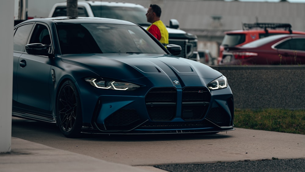 a blue sports car parked on the side of the road