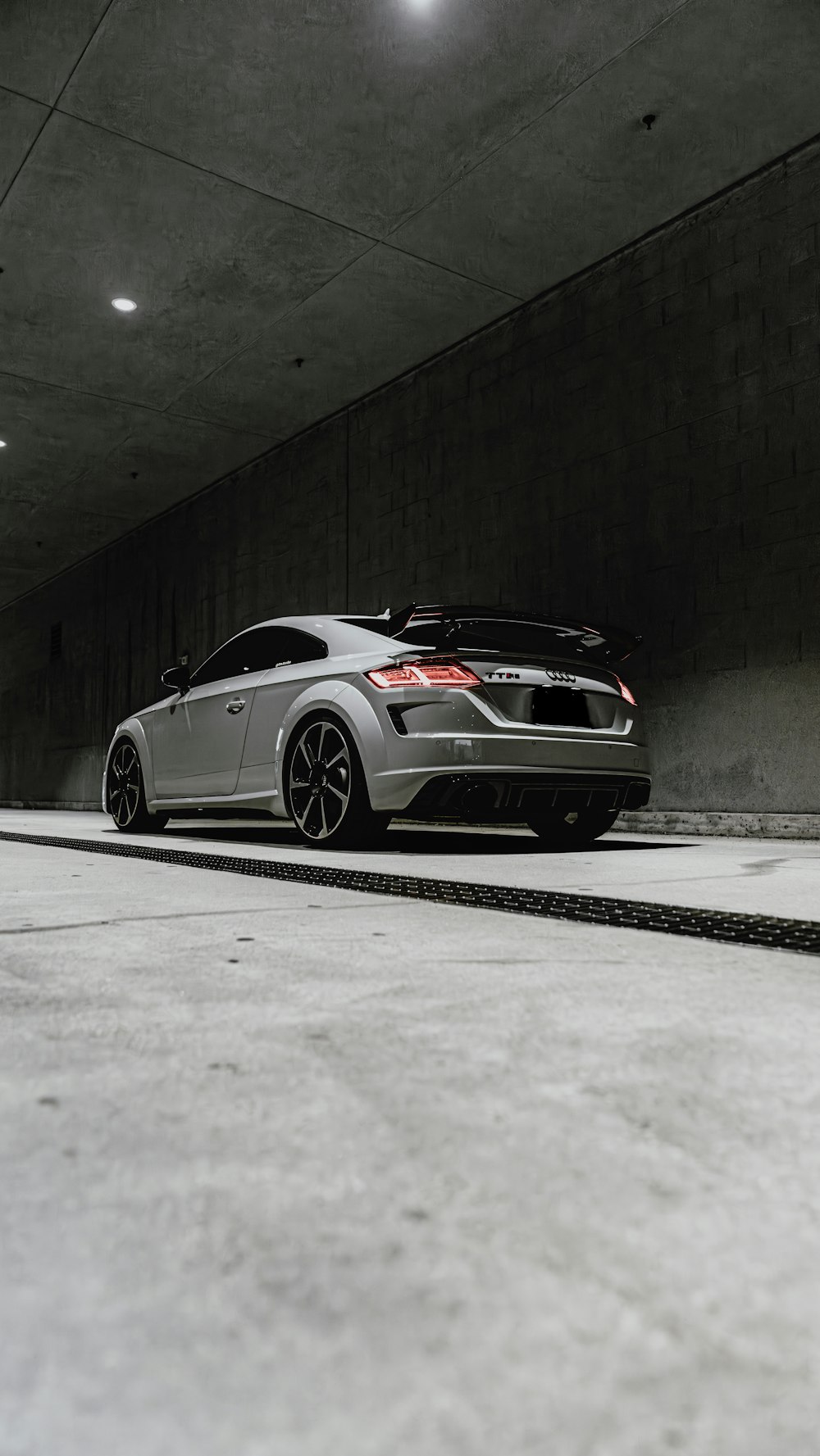 a silver car parked in a parking garage