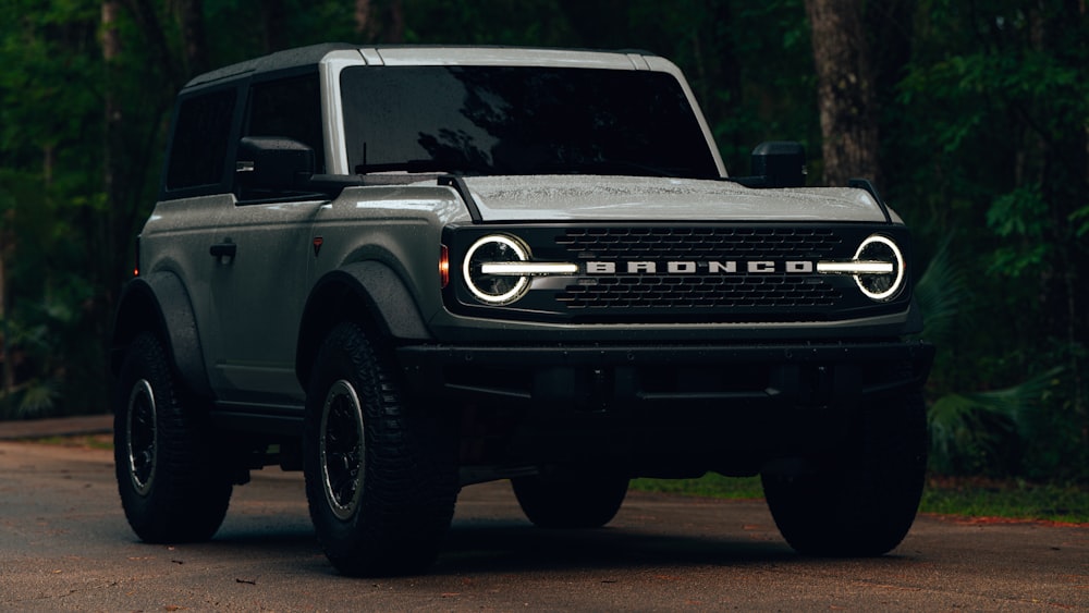 a grey truck parked on the side of a road