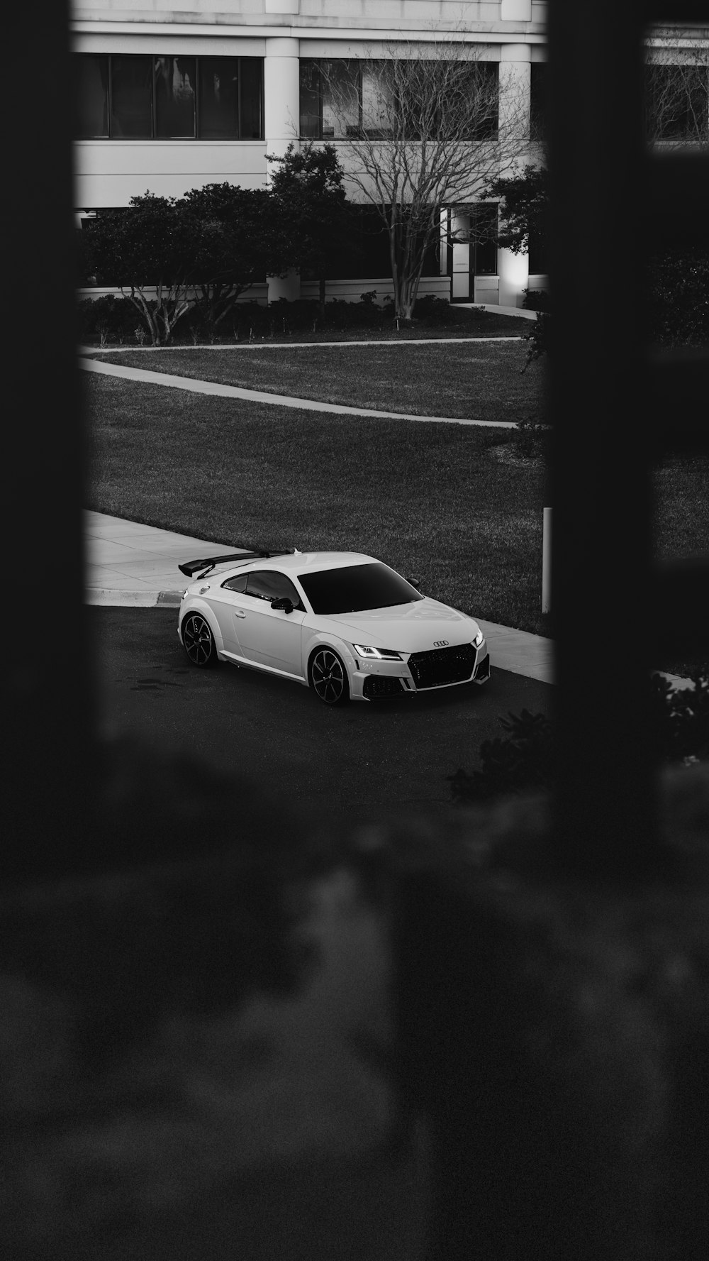 a white car parked in front of a building