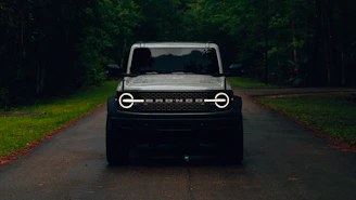 a black jeep is parked on the side of the road