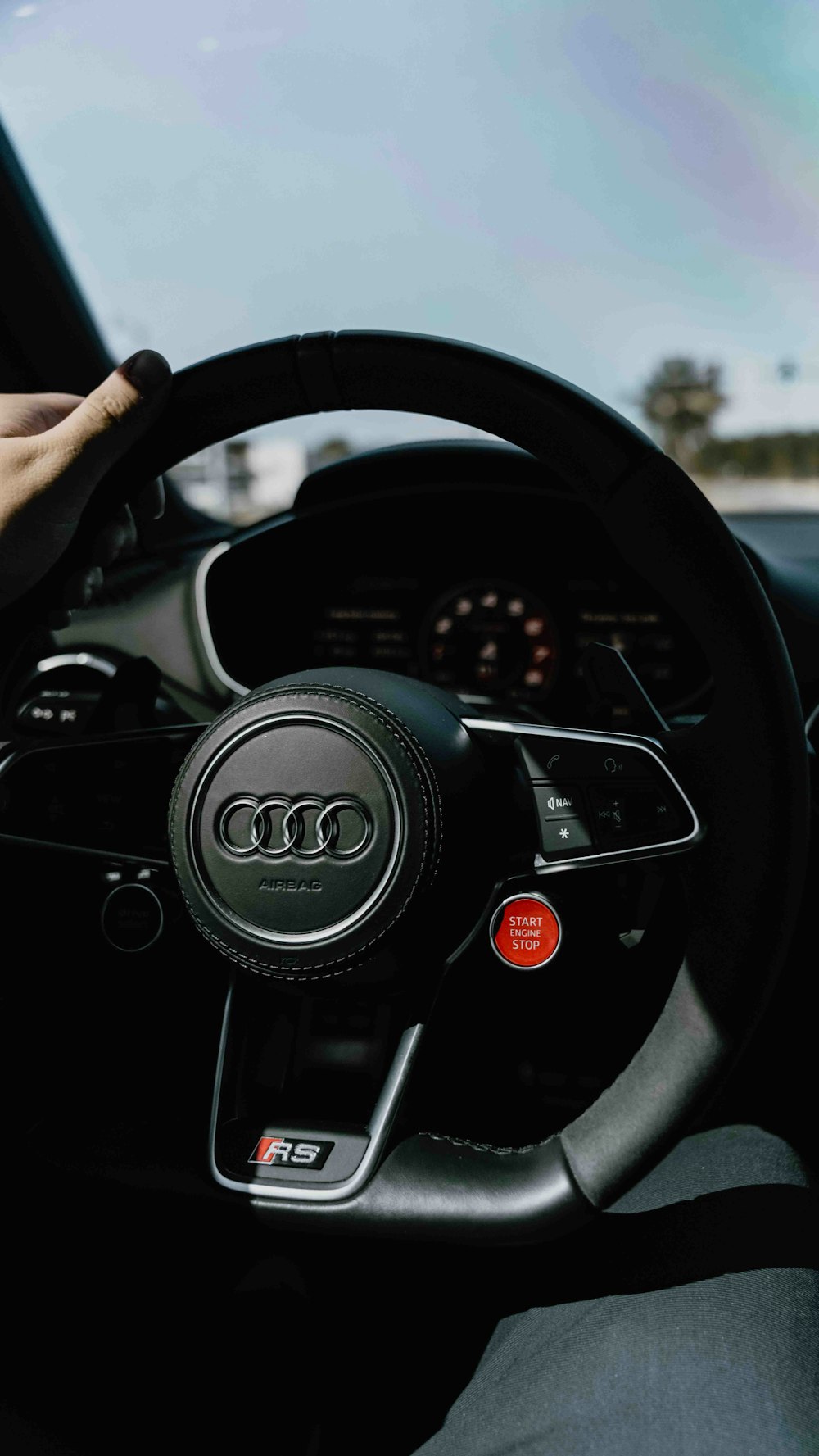 a person driving a car with a steering wheel