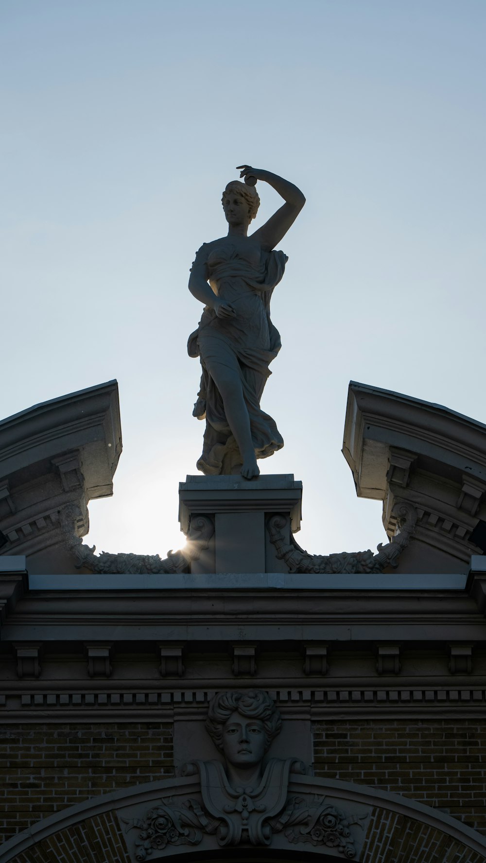 a statue of a woman on top of a building