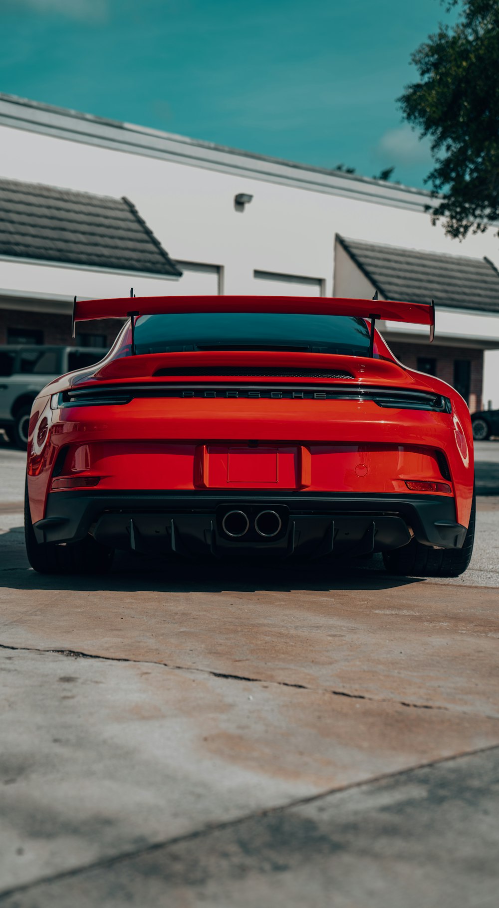 a red sports car parked in front of a building