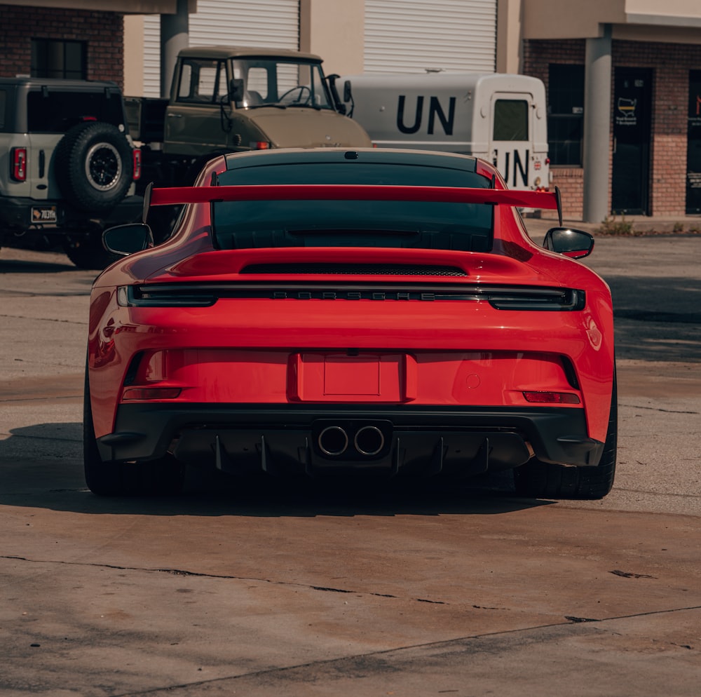 a red sports car parked in a parking lot