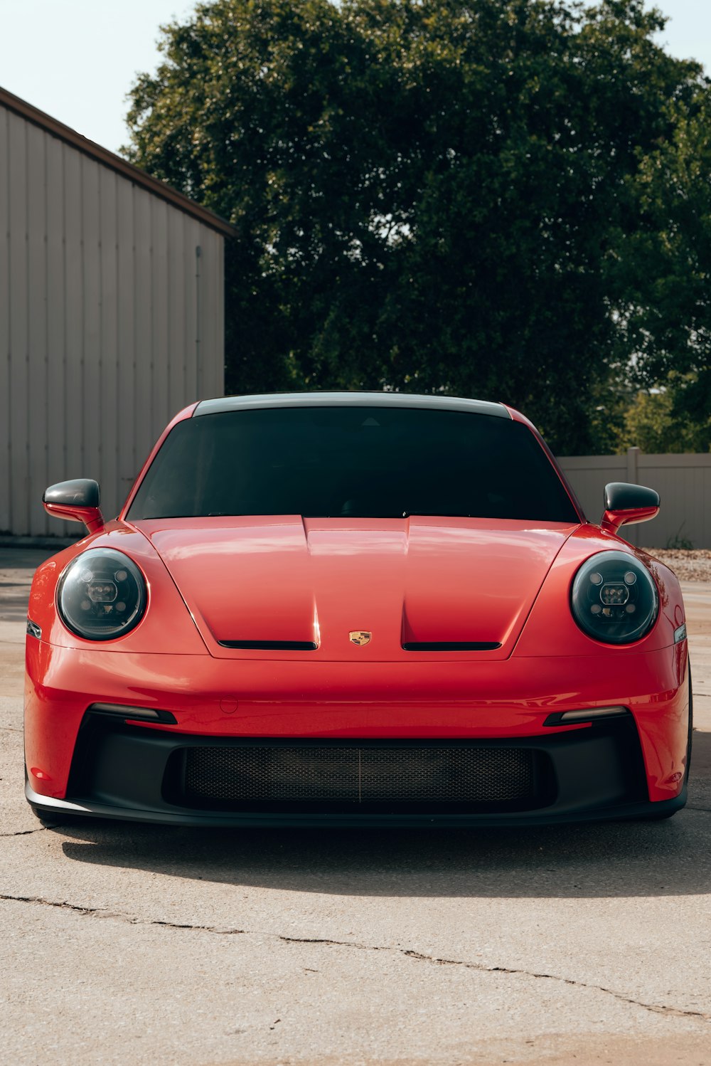 a red sports car parked in a parking lot