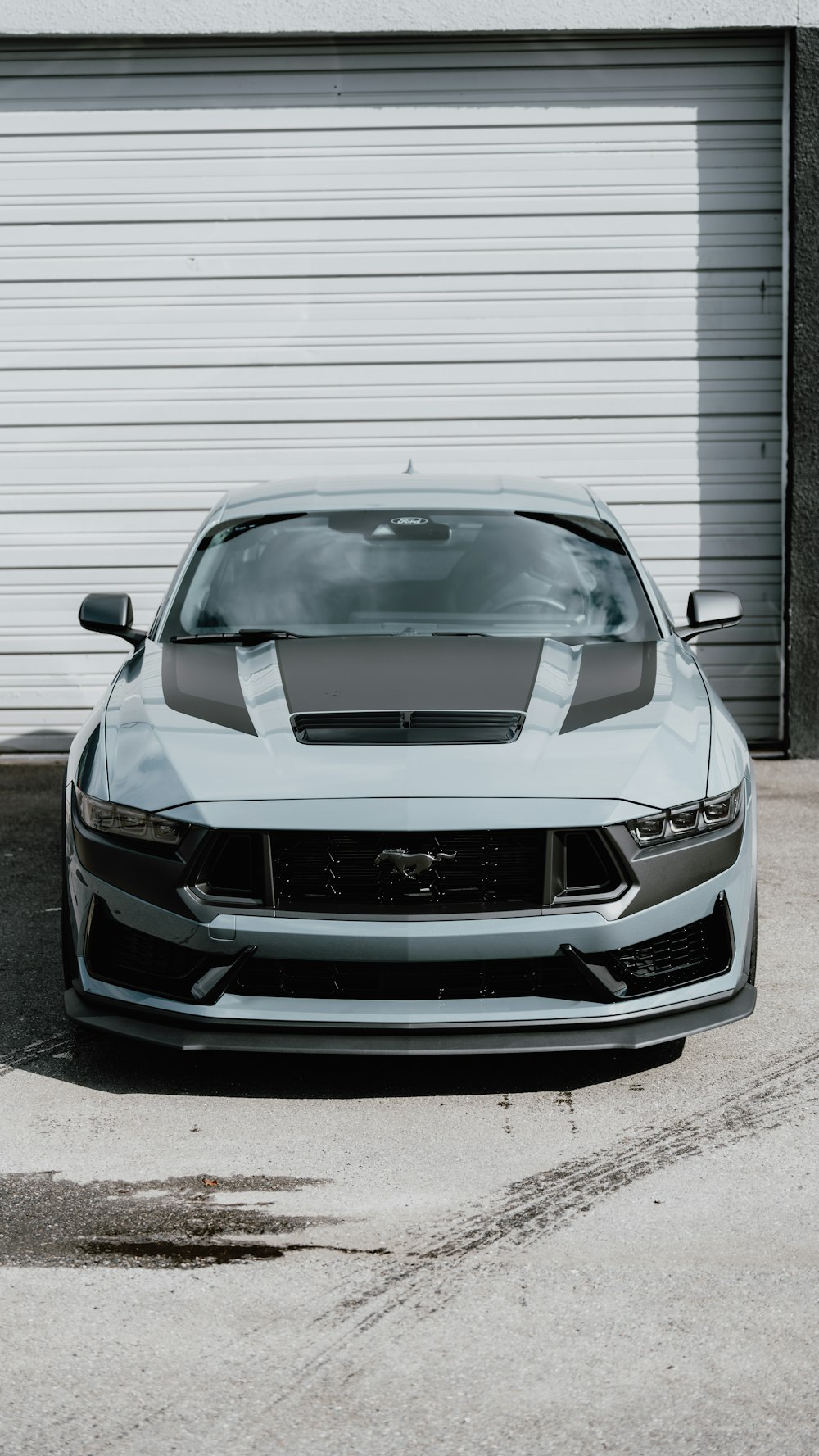 a car parked in front of a garage door