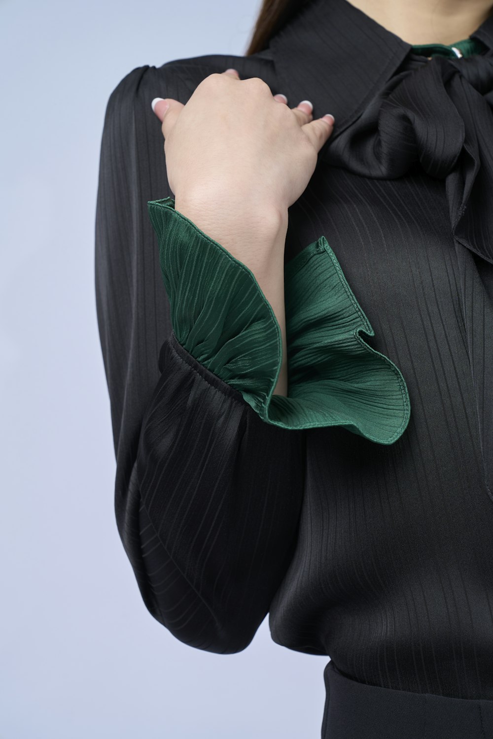 a woman wearing a black shirt with a green bow