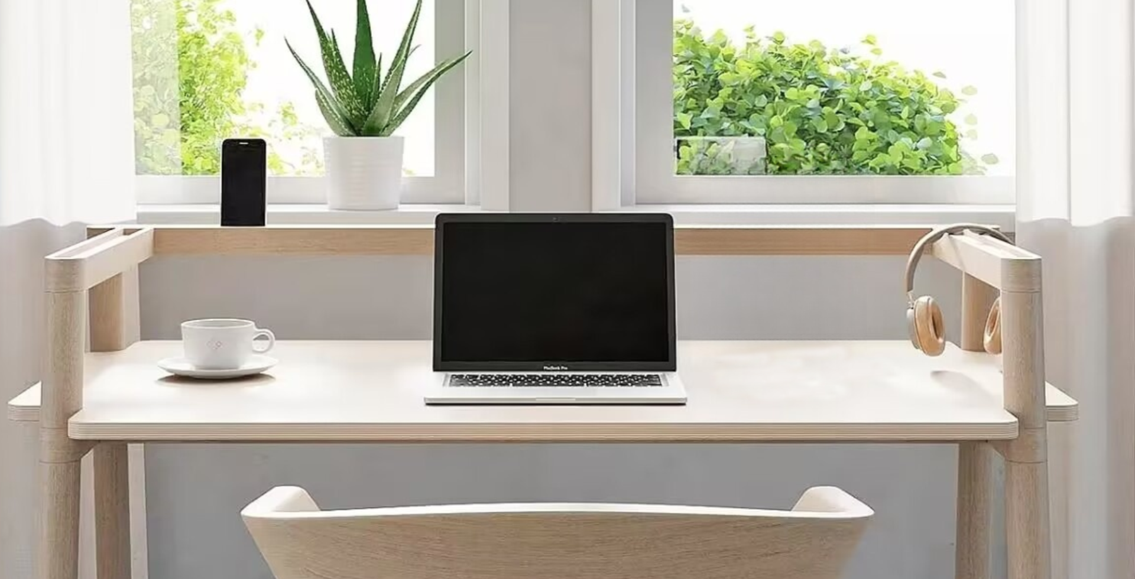 Clean desk with CV document, pen, and laptop in bright office light