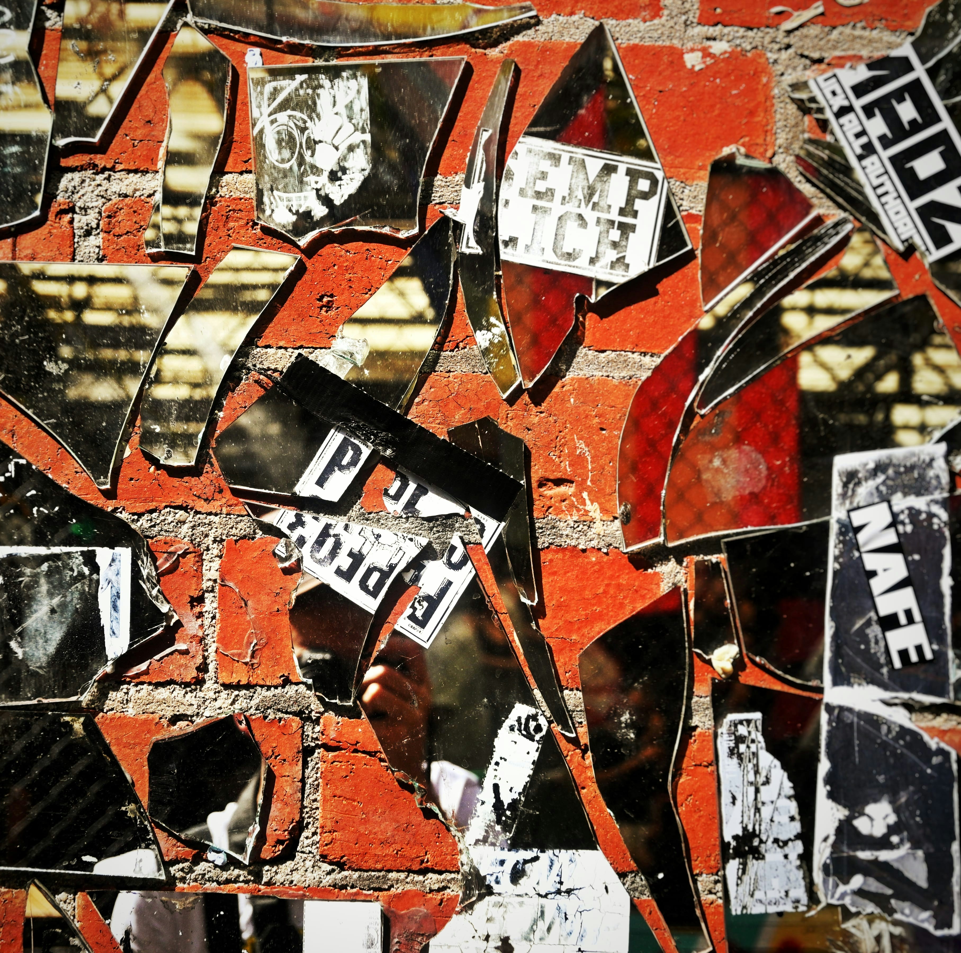a red brick wall with a bunch of mirrors on it
