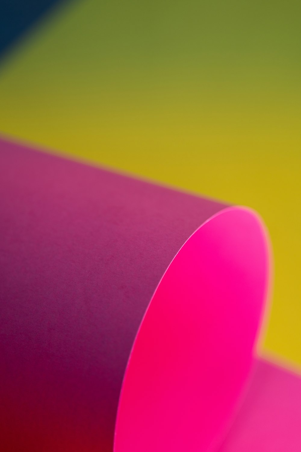 a close up of a pink tube on a yellow and green background