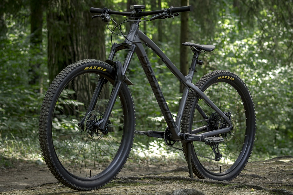 a mountain bike parked in a wooded area