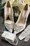 a pair of shoes and a necklace on a table