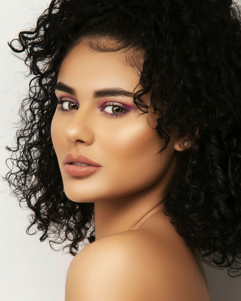 a close up of a woman with curly hair