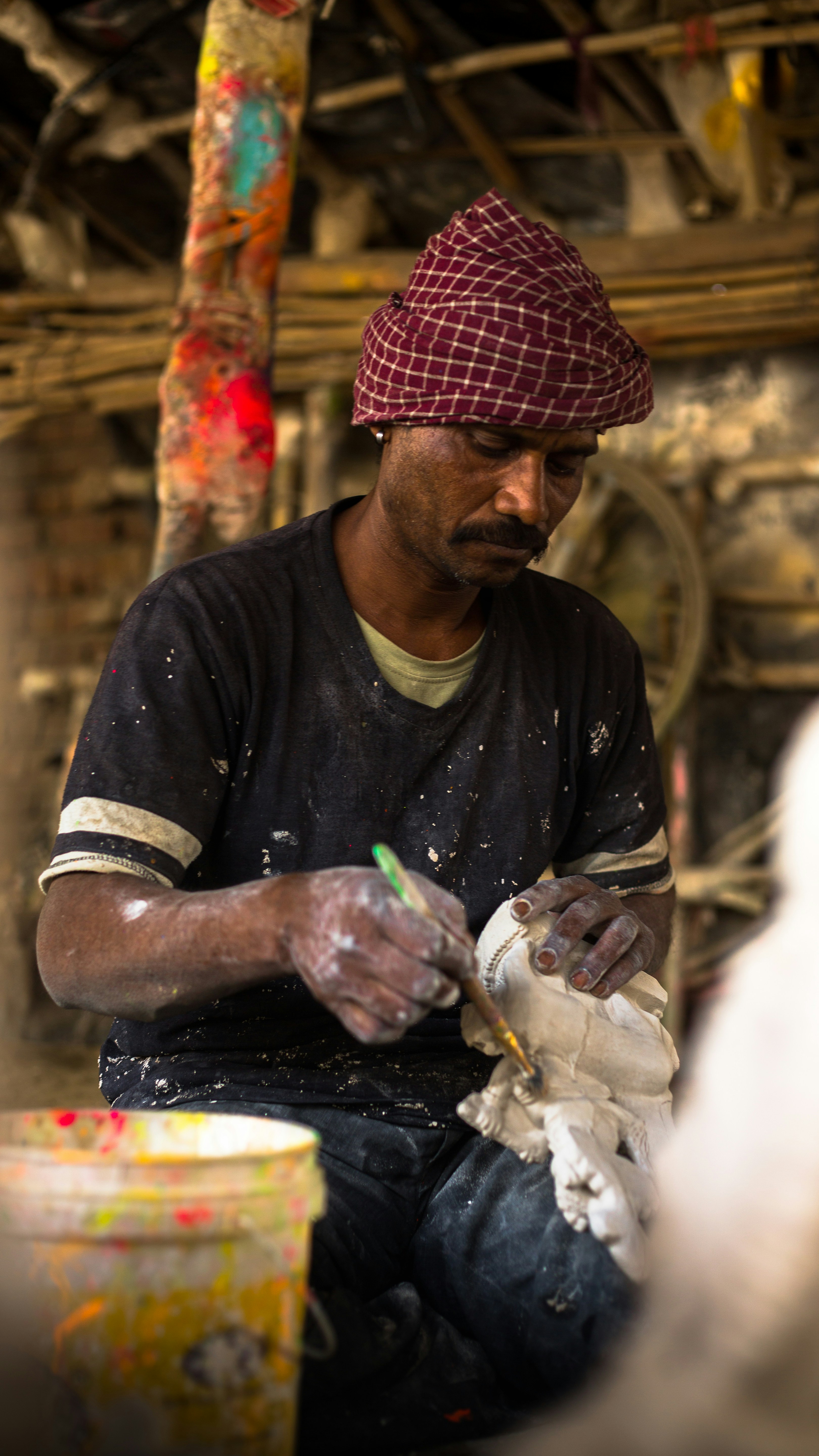 a man sitting on the ground working on something