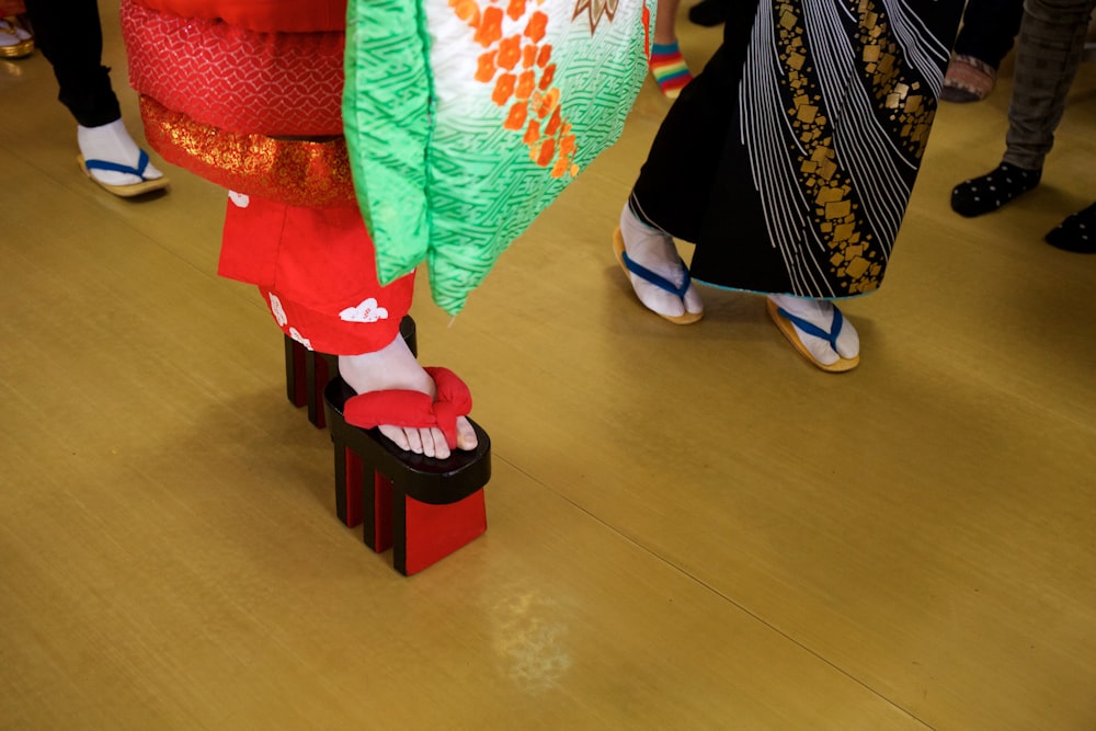 a group of people standing around a wooden floor