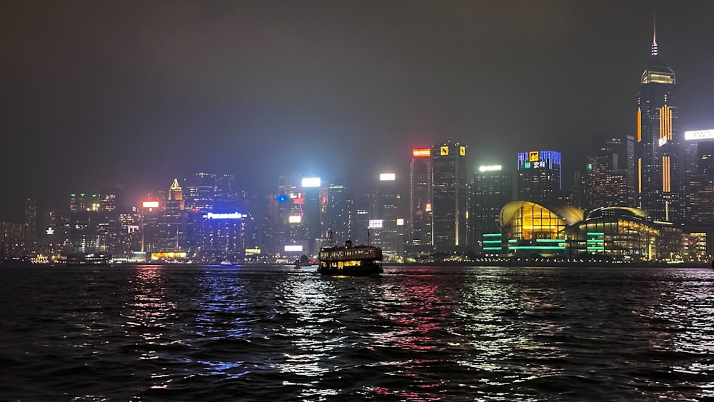 a boat in a body of water with a city in the background