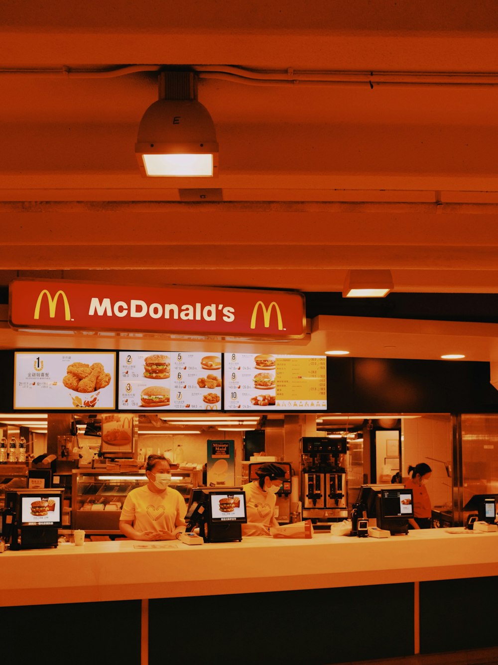 a mcdonald's restaurant with a man behind the counter