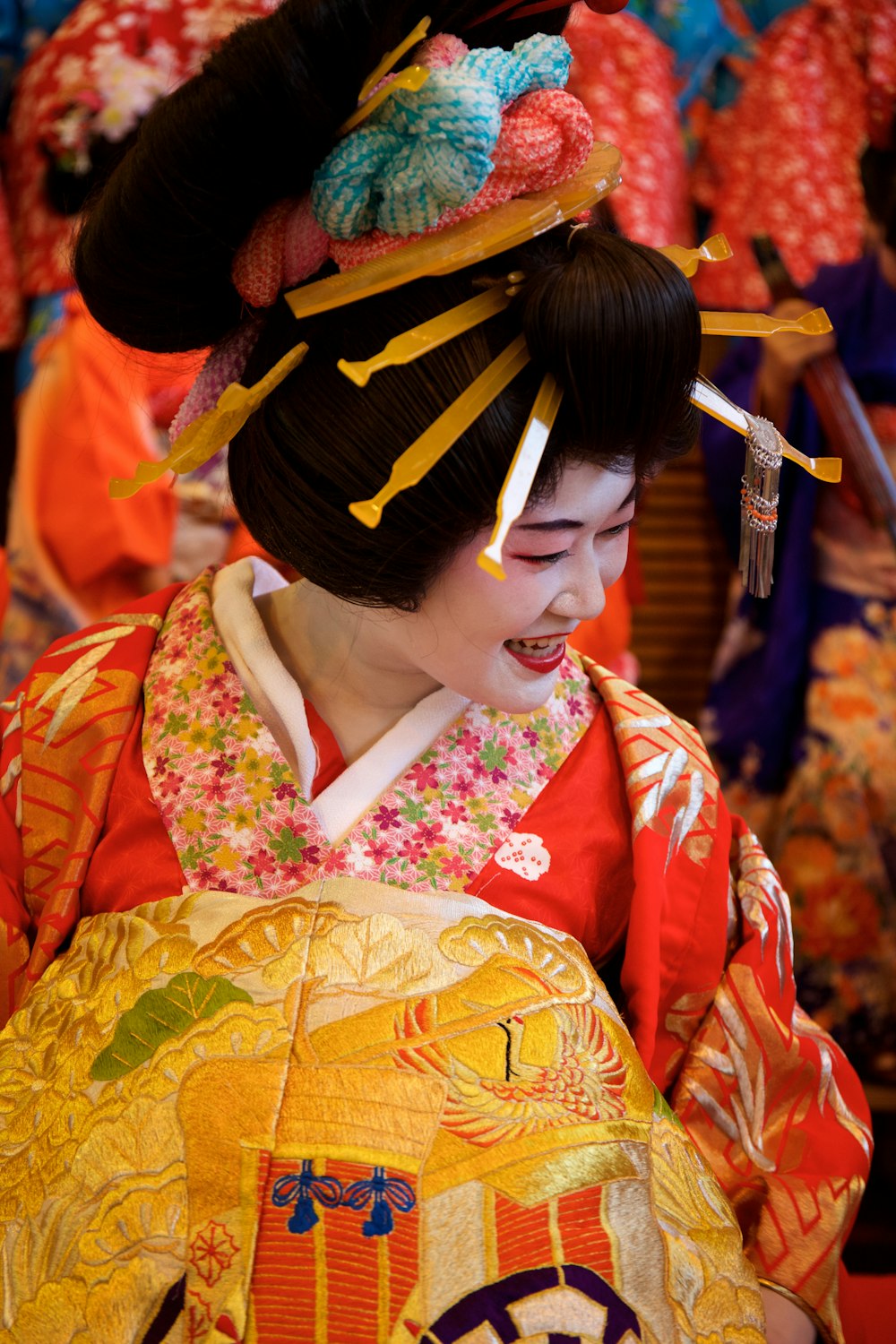 a woman in a geisha dress holding a fan