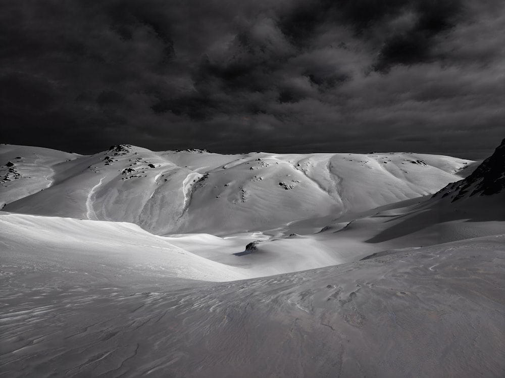 a black and white photo of a snow covered mountain