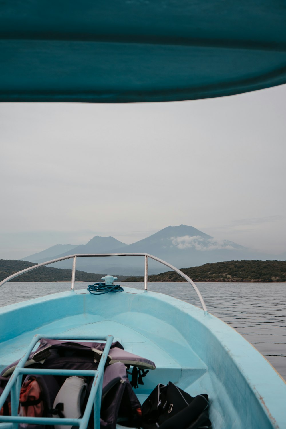 a blue boat with a lot of luggage on it