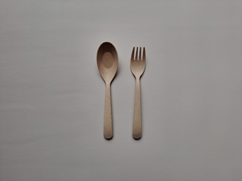 a couple of spoons and a fork on a table