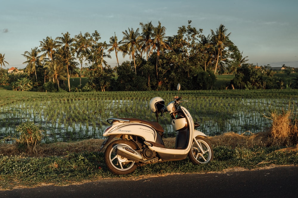 a motor scooter parked on the side of a road