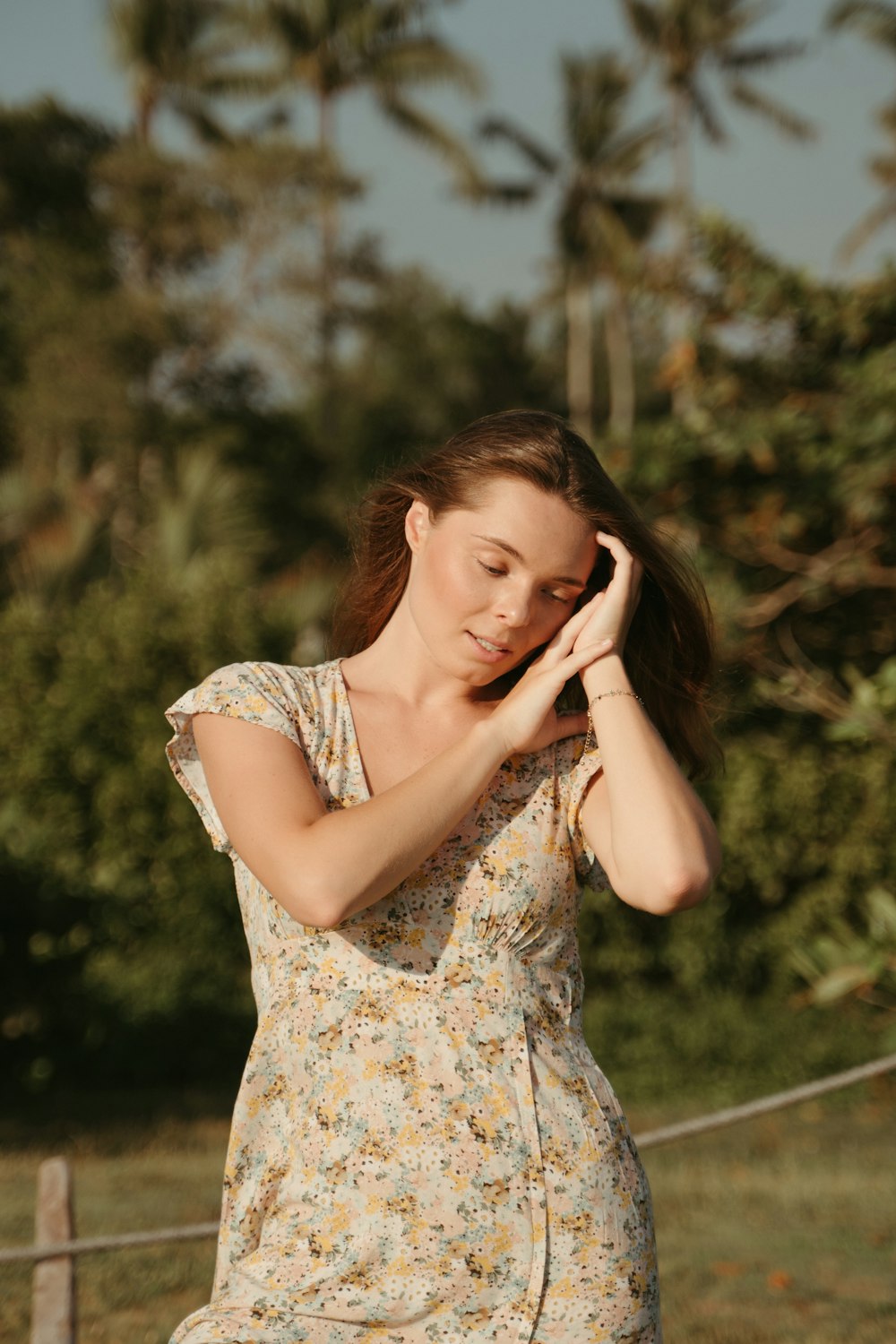 a woman in a dress talking on a cell phone