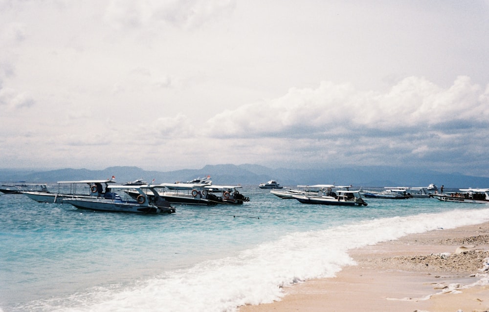a group of boats sitting on top of a beach