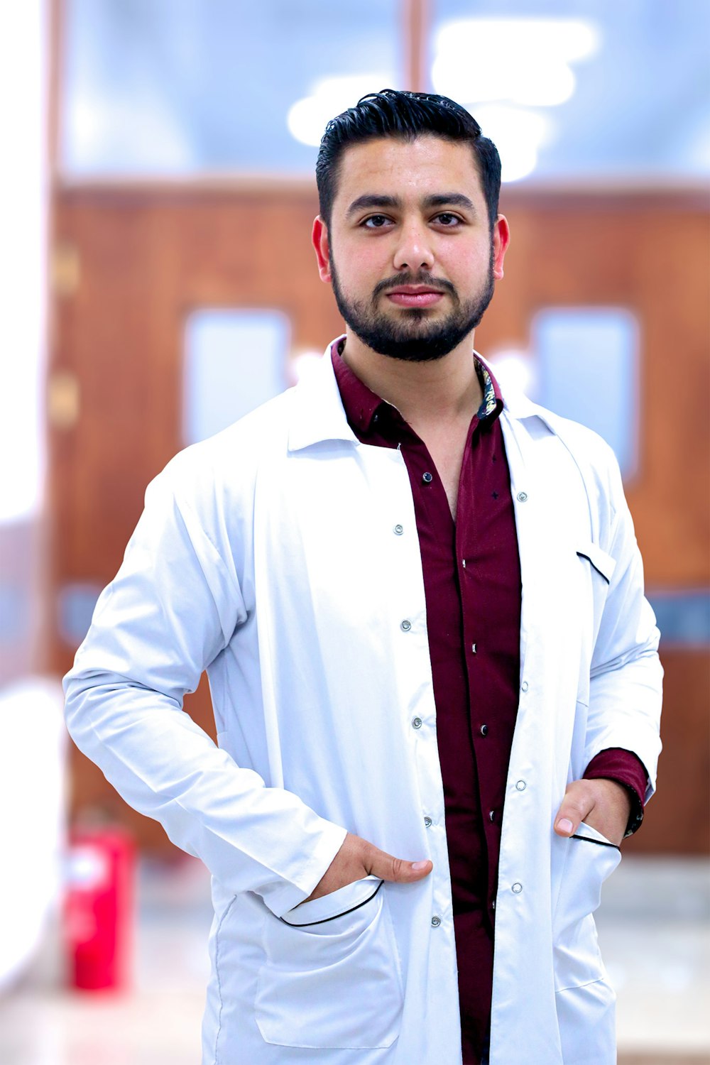 a man in a lab coat standing with his hands on his hips