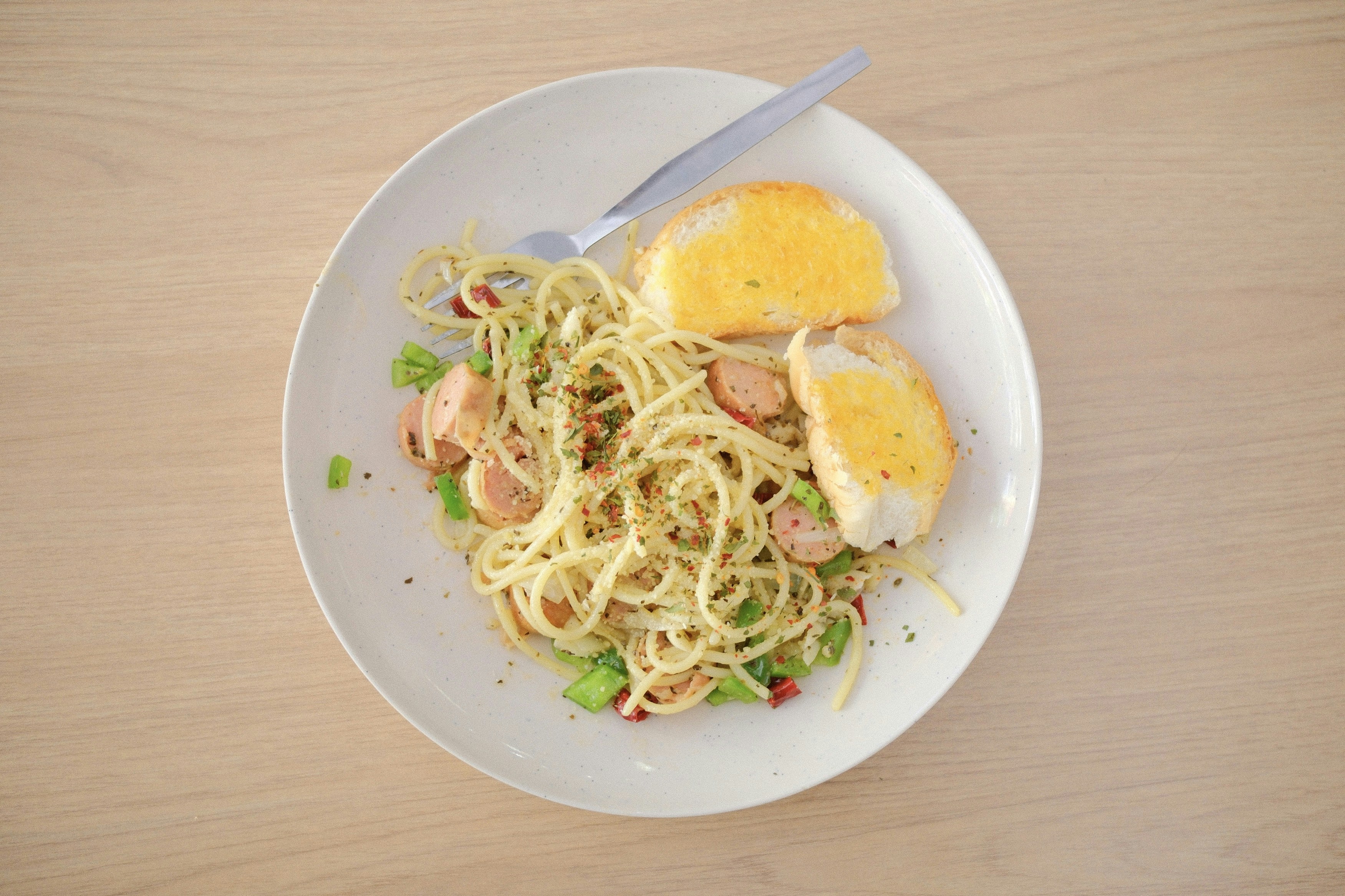 a white plate topped with pasta and meat