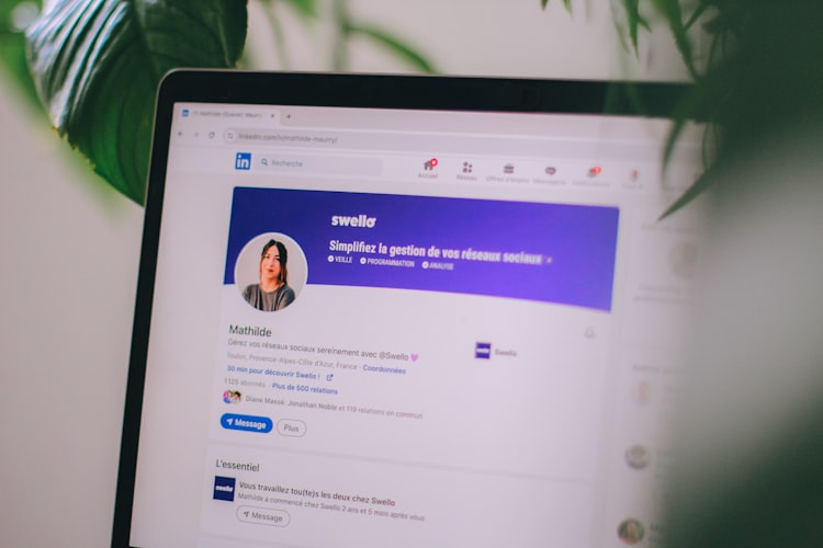 LinkedIn profile page on laptop showing optimized personal brand