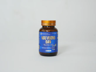 a bottle of vitamin supplement on a white background