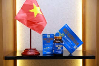 a table with a flag, pills, and other items on it