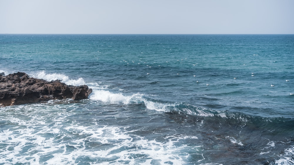 a rock outcropping in the middle of the ocean