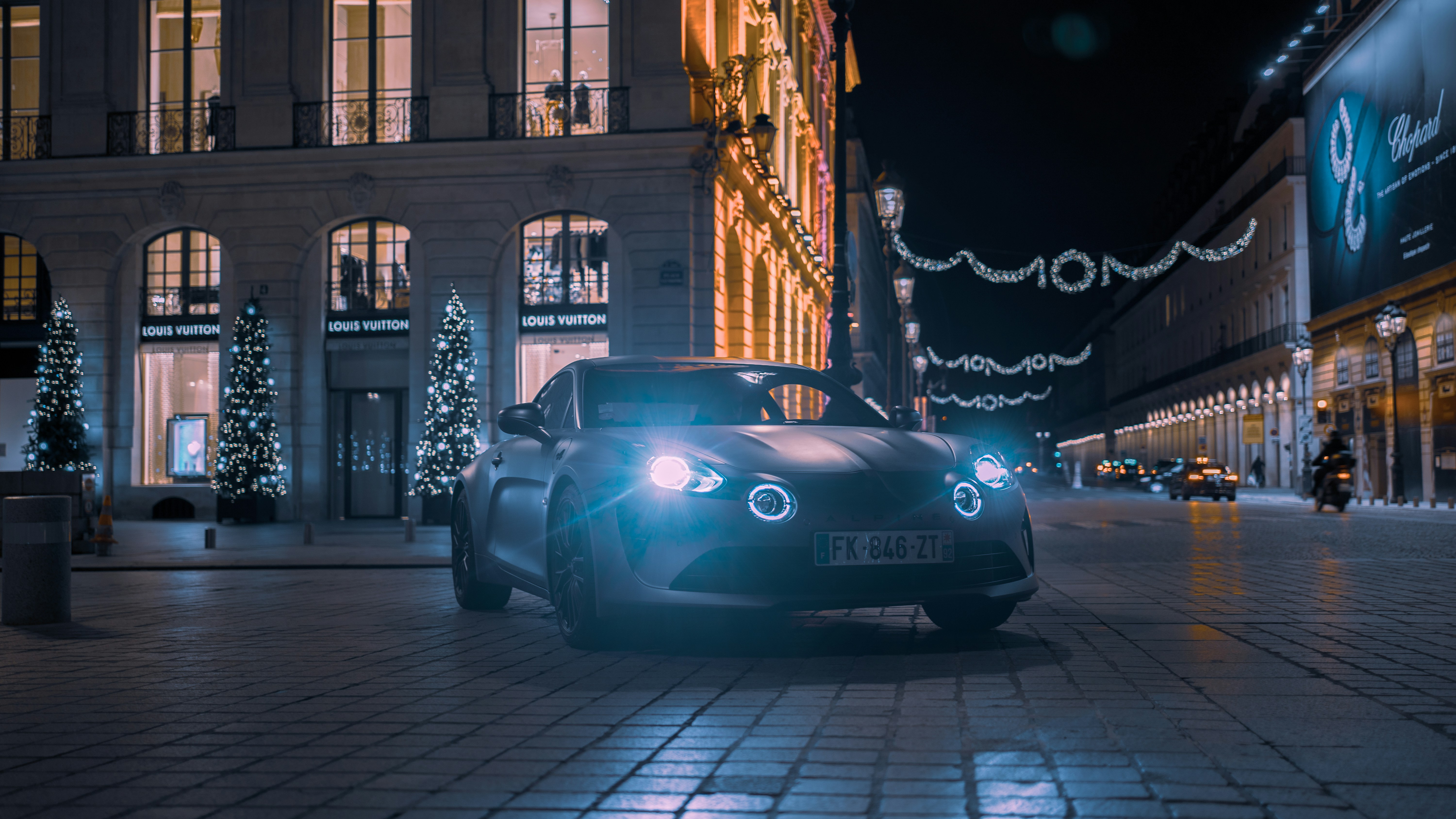 A car driving down a city street at night photo – Free Car Image on ...