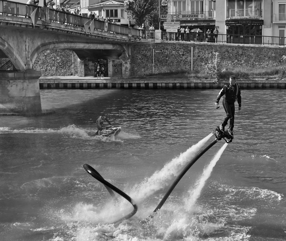 a black and white photo of a man on water skis