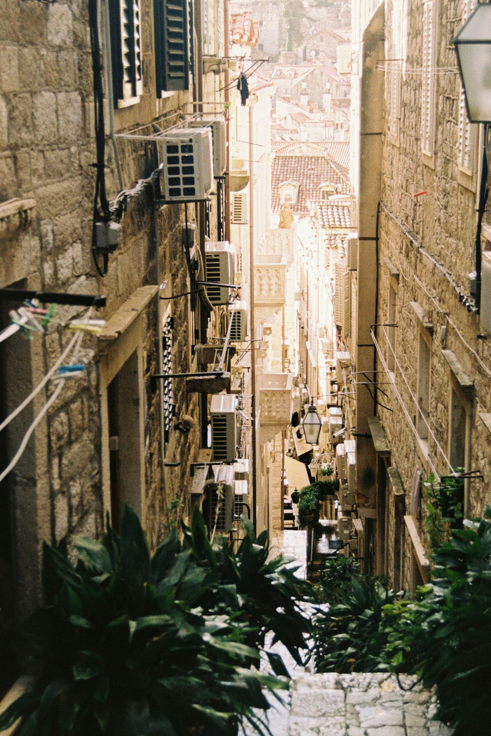 a narrow alley way with a clock on the wall