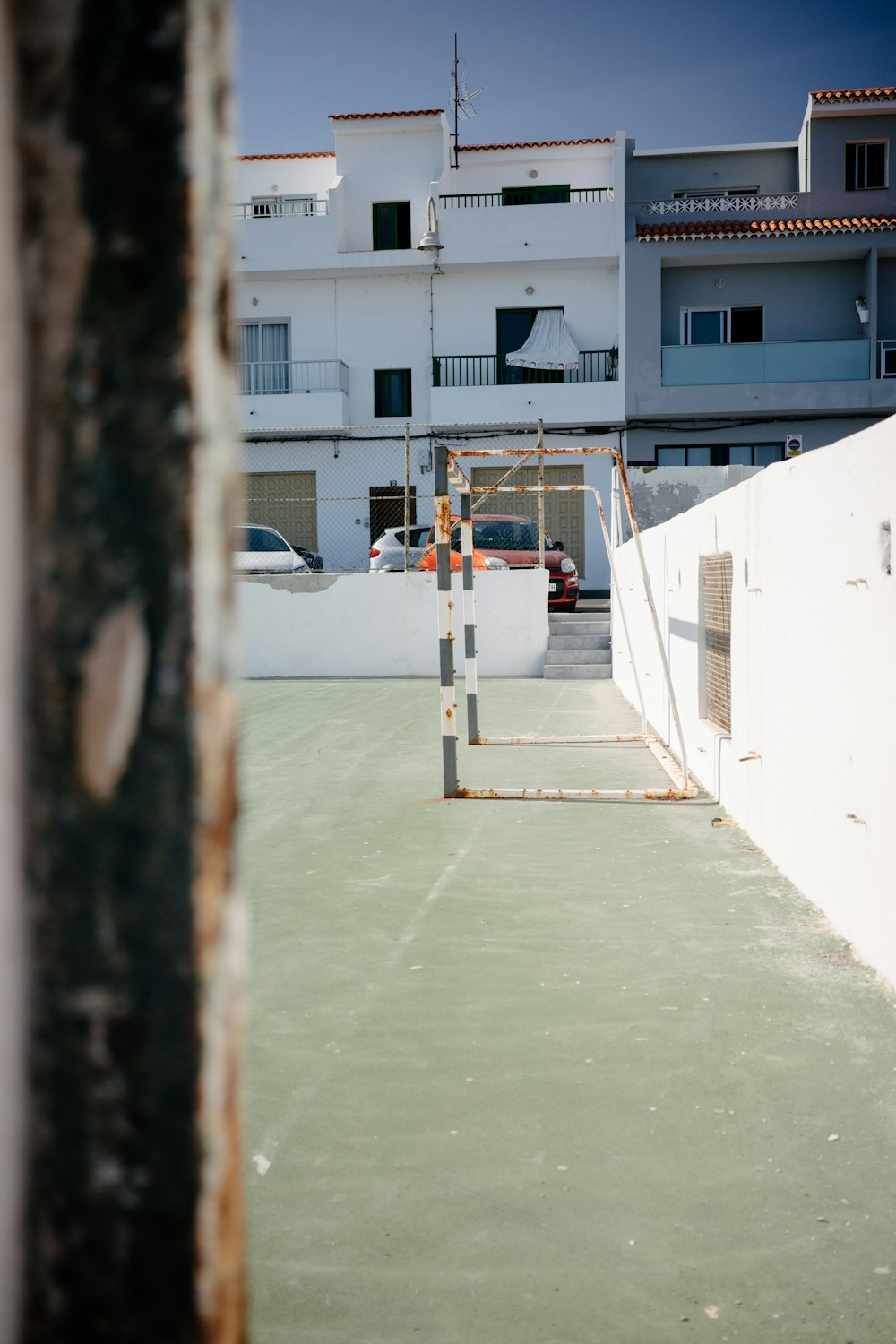 a tennis court with a building in the background