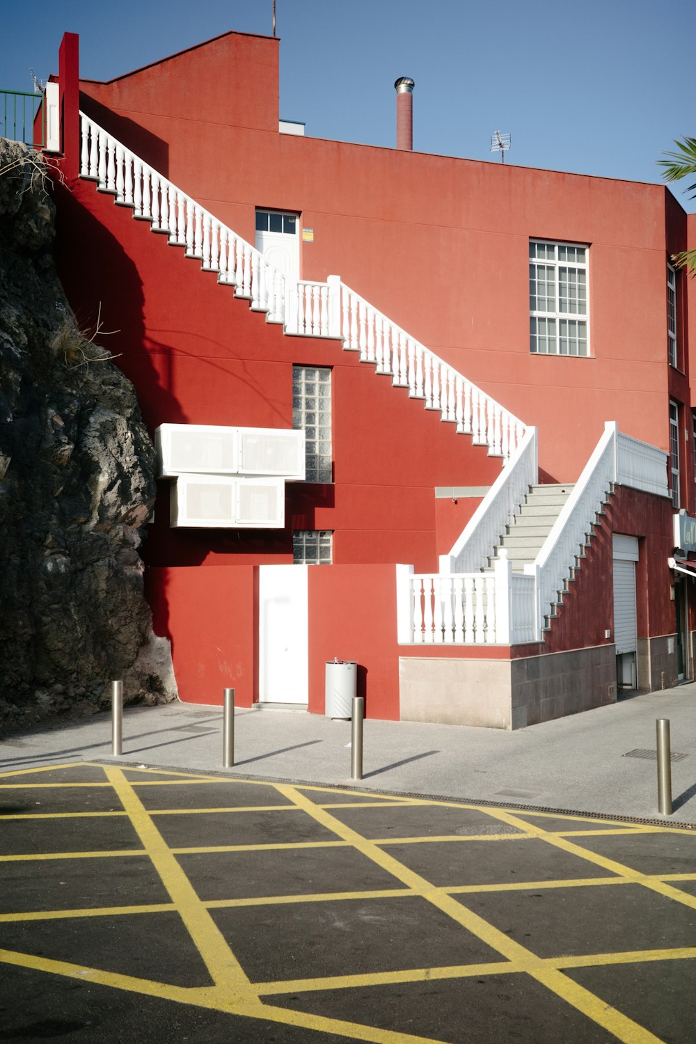 a red building with a white staircase next to it