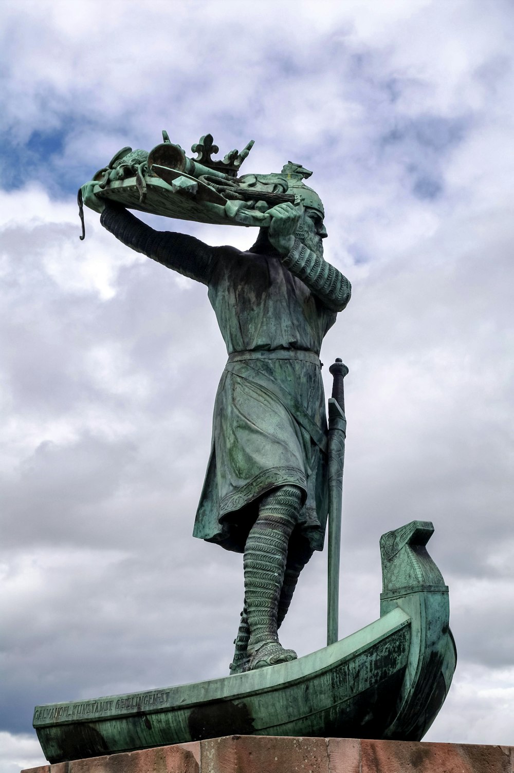 a statue of a man standing on a boat