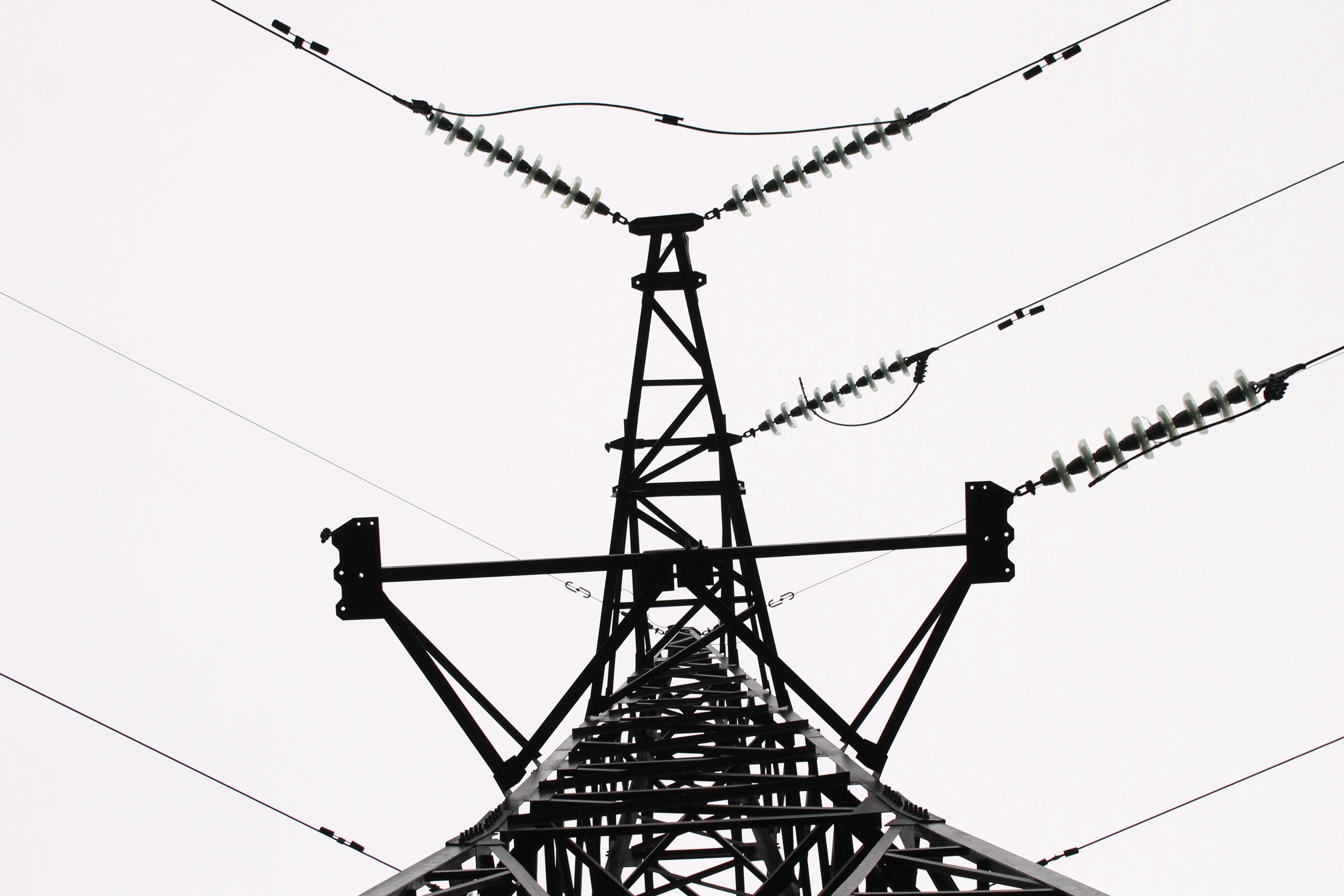 a tall tower with lots of power lines above it