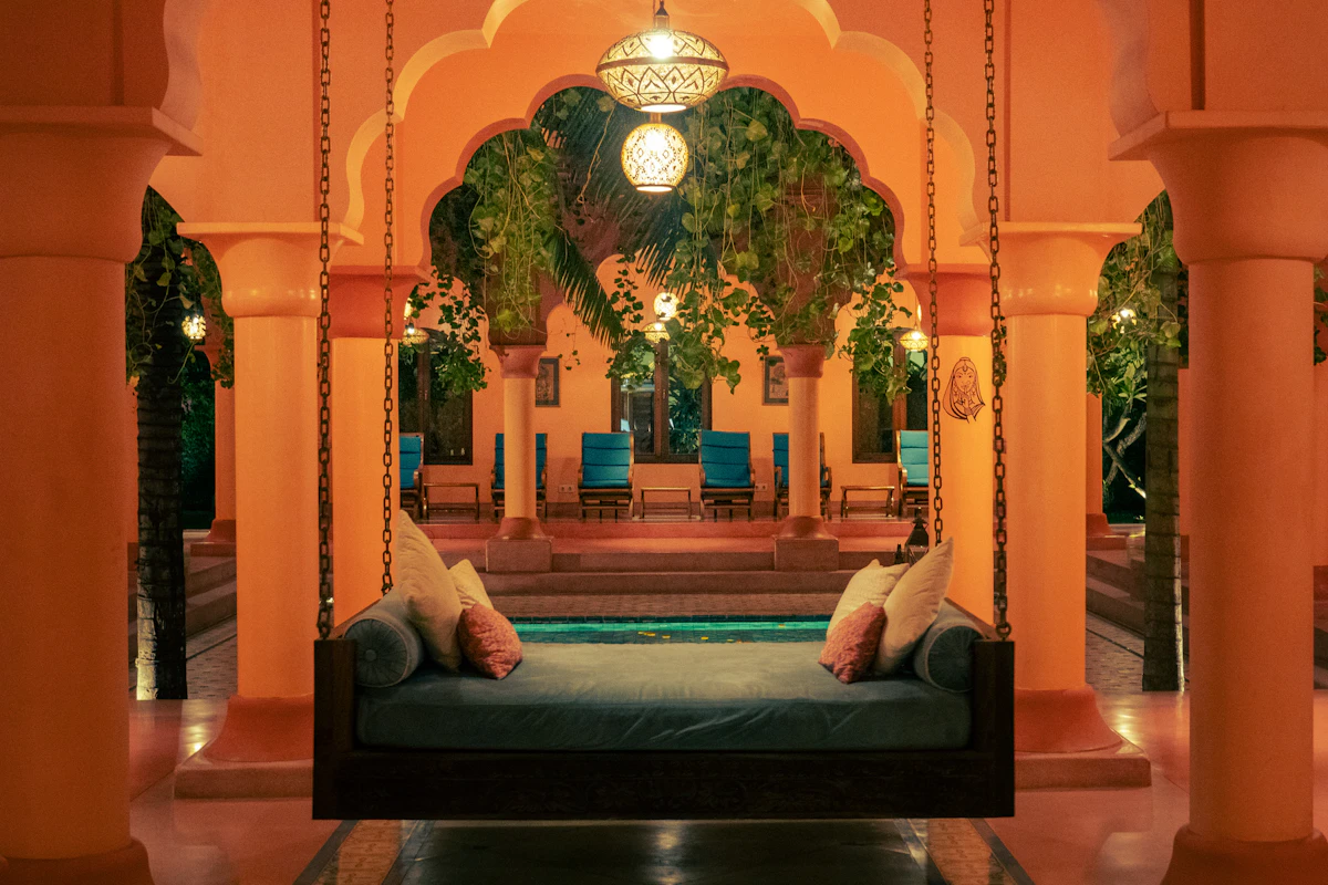 Courtyard seating under an archway beside the pool at an Indian heritage hotel